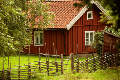 A House With A Fence In A Field