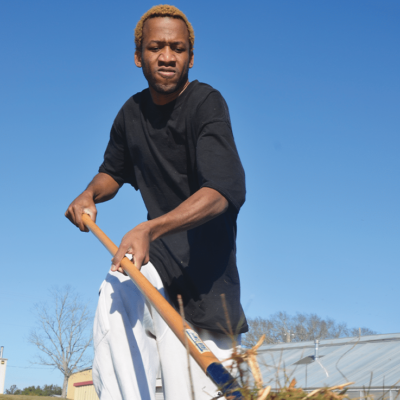 A Man Holding A Pole