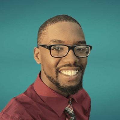 a man wearing glasses and looking at the camera